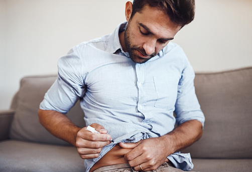 Man giving himself an insulin shot