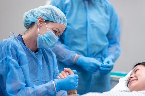 Woman talking with doctor before surgery