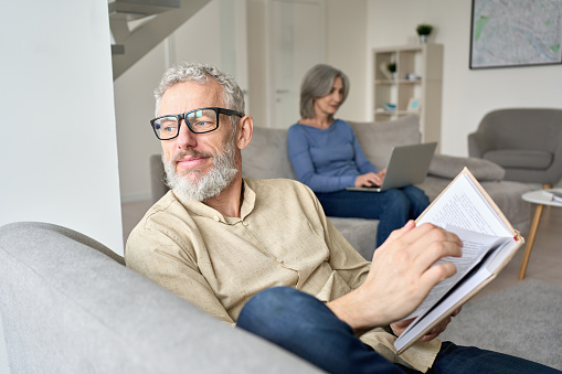 Couple reading in their living room