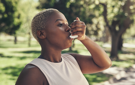Woman outdoors with inhaler