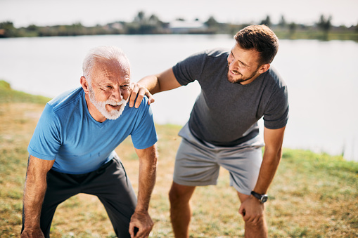 Man and father resting while exercising