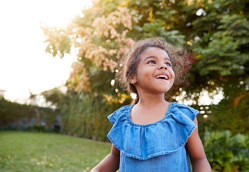 Young girl playing in back yard