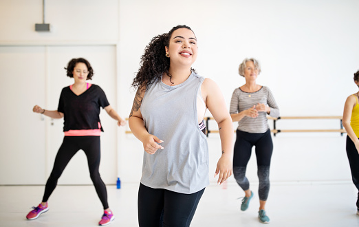 Woman learning dance moves in a class