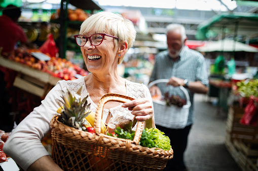 Senior couple shopping for produce