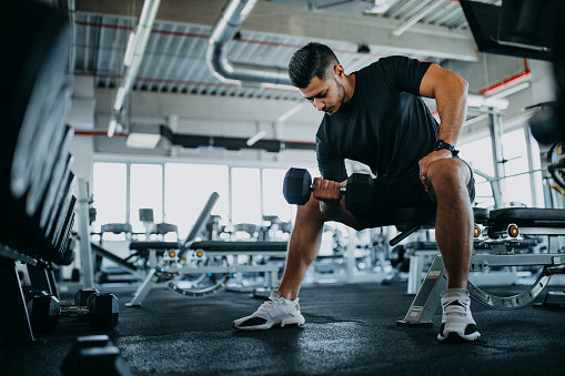 Man lifting weights in gym