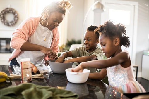 Mother and children mixing ingredients